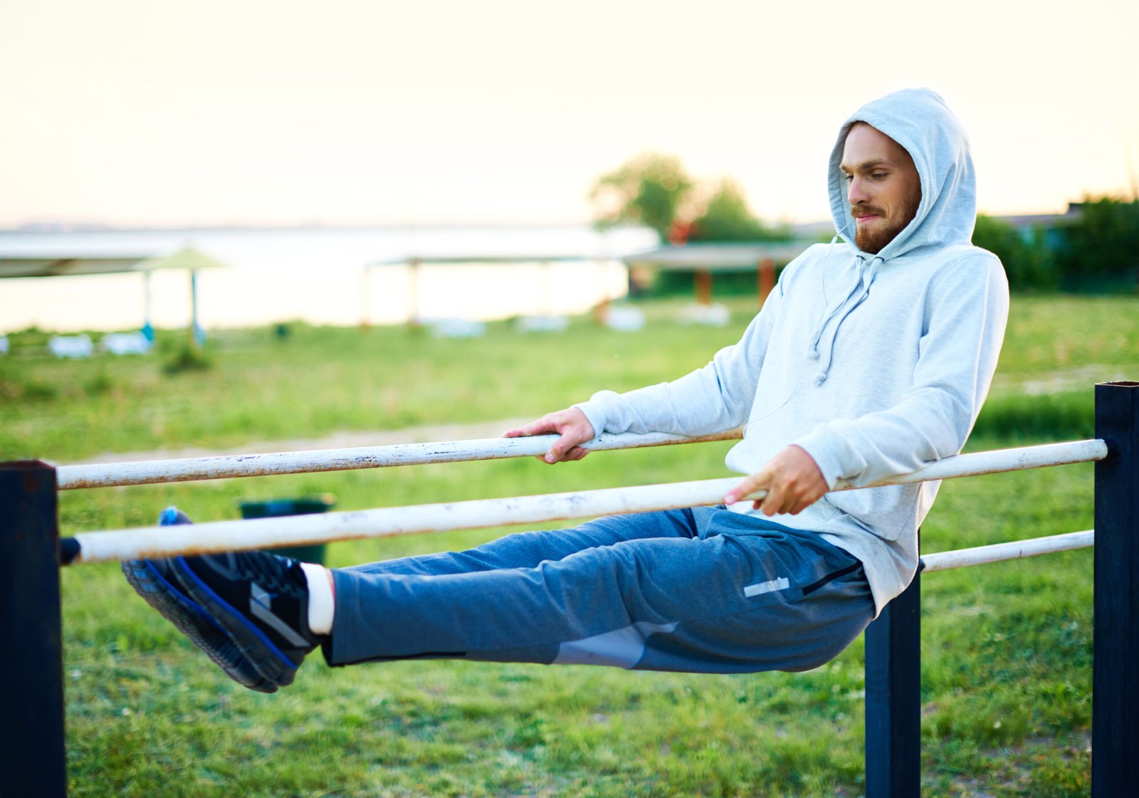 Man doing calisthenics while wearing a sauna suit.