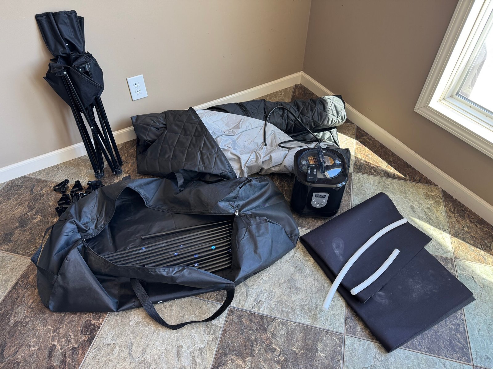 All of the items included in the saunabox smartsteam pro package layed out on the floor